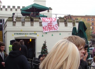 A banner saying "No tax = No NHS" hung from Starbucks